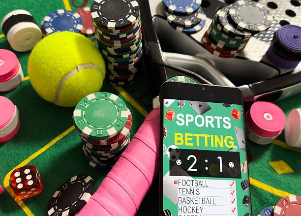 Live dealer in a studio setting with headset, speaking to players and gesturing to the Sic Bo dice cage